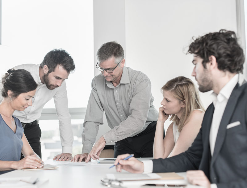 group of 1848 employees discussing a project in a conference room